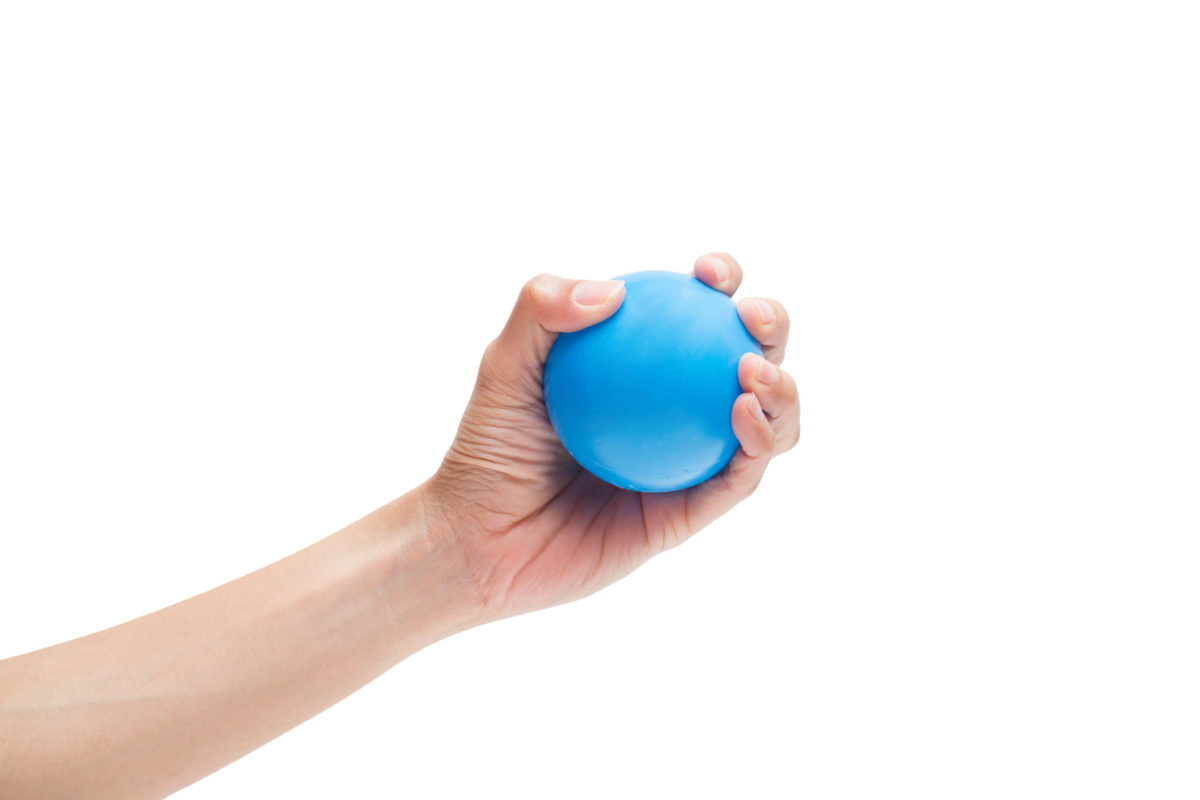 Image of a woman’s hand squeezing a blue stress ball.