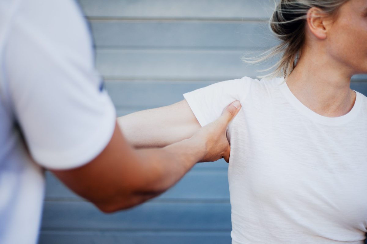 Image of young female receiving shoulder treatment for pain.