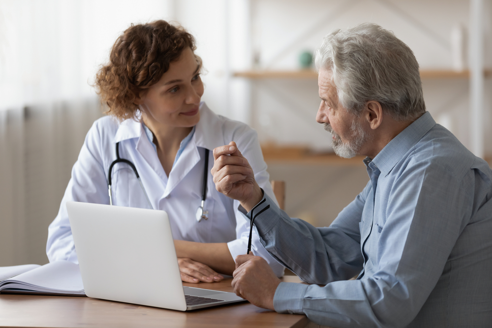  A doctor and patient discuss a PRP shot. 