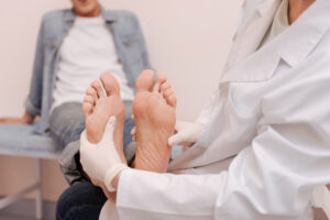 A foot doctor examines a patient’s foot.